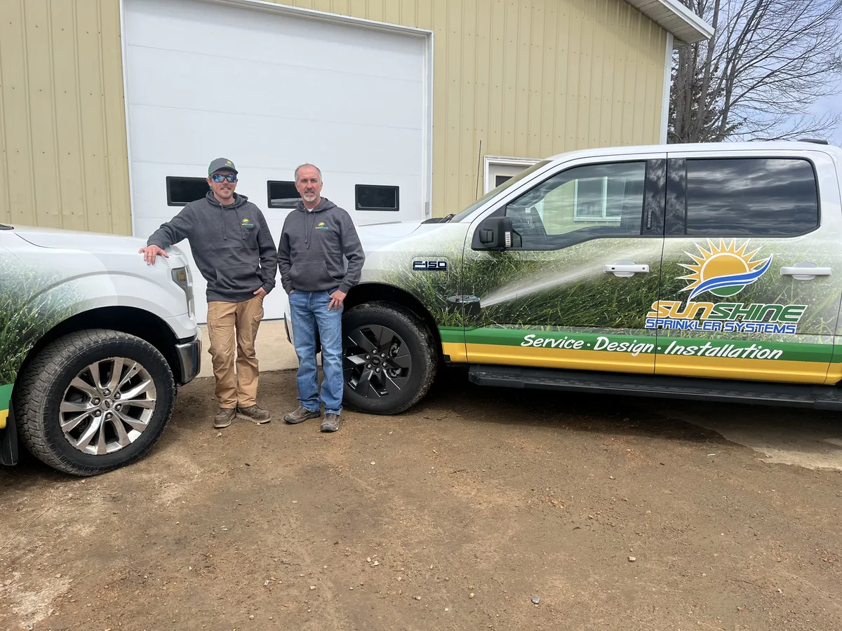 Jon and Sam Maeyaert in front of the Sunshine Sprinkler truck