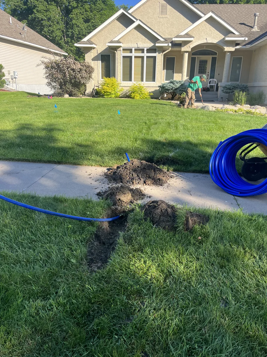 Irrigation pipe being run through a lawn during installation